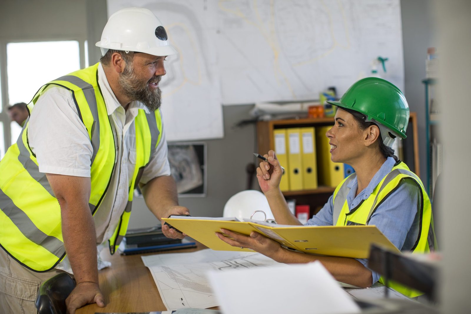 Quarry worker checking files in an office